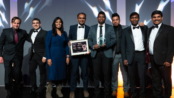 Picture of team holding award and certificate at awards ceremony